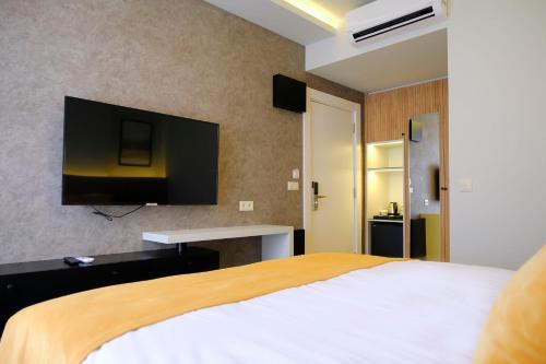 a bedroom with a bed and a tv on the wall at Dugi Hotel in Istanbul