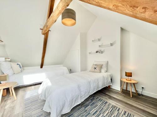 Ένα ή περισσότερα κρεβάτια σε δωμάτιο στο Gîte Duplex-Ocean Moderne dans longère avec extérieur