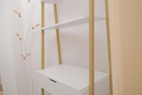 a white cabinet with white shelves in a room at Kastoras Apartments in Kardamili