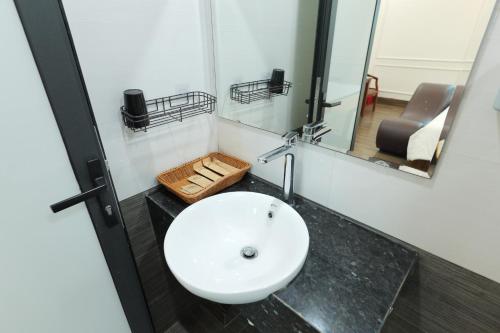 a bathroom with a white sink and a mirror at Trang Anh Hotel Bắc Giang in Bắc Giang