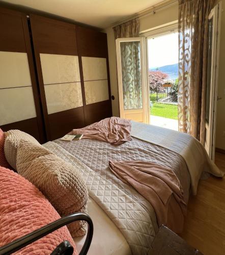 a bedroom with two beds next to a window at Serra Boutique Villa & Spa in Ghiffa