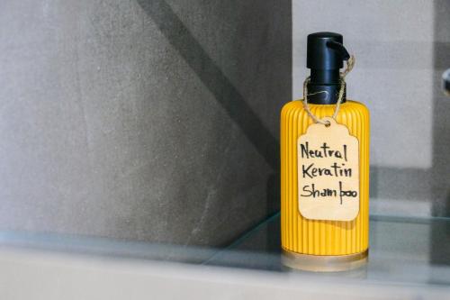 a bottle of mustard sitting on a shelf with a tag on it at Agorà Connect Space in Brindisi