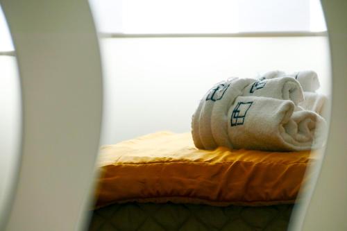 a stuffed elephant statue sitting on top of a bed at Agorà Connect Space in Brindisi