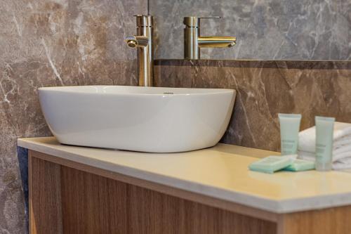 a white sink on a counter in a bathroom at Hotel HM Alma de Bayahibe - Adults Only - All Inclusive in Bayahibe