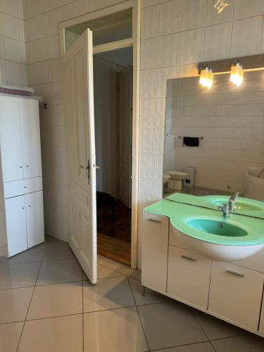 a bathroom with a sink and a mirror at Pepermint in Osijek