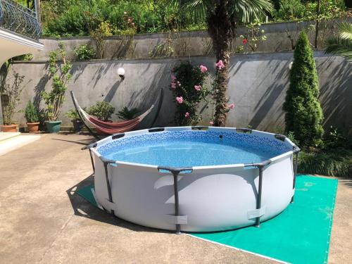 a hot tub in a yard with plants at Villa Near The Batumi in Batumi