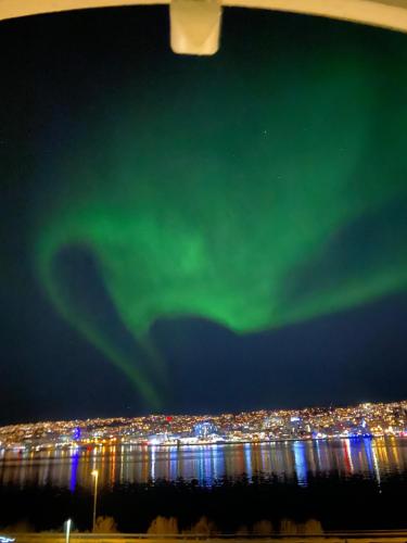 an image of the aurora in the sky over a city at Arctic Villa Tromsø in Tromsø