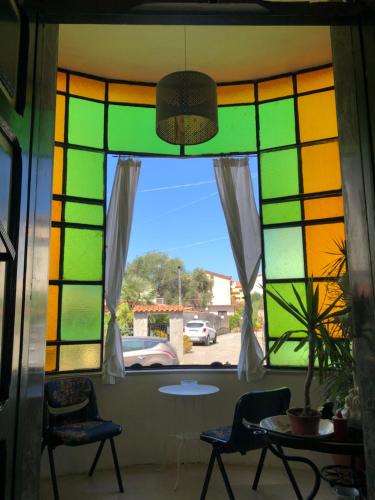 a stained glass window in a room with two chairs at B&B Villa Fiorita in Marina di Camerota