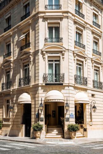 a large building with balconies on a street at Hôtel Balzac Paris & Spa Ikoï in Paris