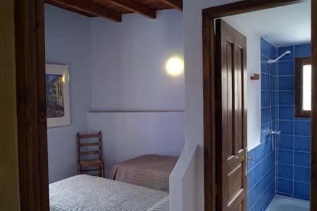 a bedroom with a bed and a bathroom with a shower at Casa Figueretes in Finestrat
