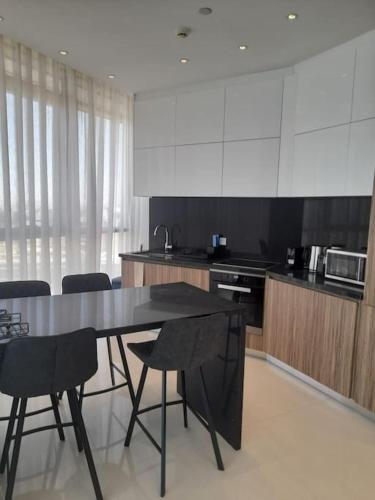 a kitchen with a table and chairs in it at 360 Nicosia-2 Bedroom City Tower in Nicosia
