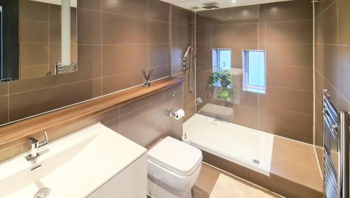 a bathroom with a sink toilet and a mirror at Unique and cozy apartment in central London in London