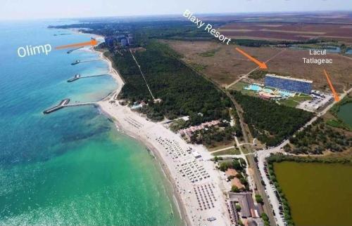 une vue aérienne d'une plage avec un complexe hôtelier dans l'établissement Waves & Whispers Apartments - acces gratuit piscina, à Olimp