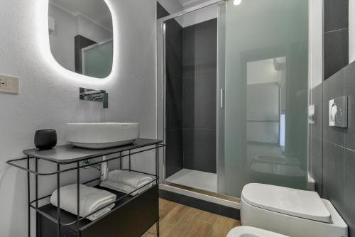 a bathroom with a sink and a toilet and a mirror at Casina Napoleonica in Lacona