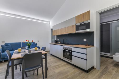 a kitchen and dining room with a table and chairs at Casina Napoleonica in Lacona
