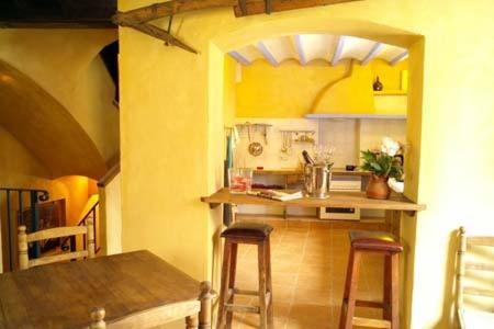 a kitchen with a table and stools in a room at Casa Figueretes in Finestrat