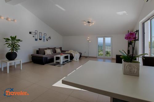 a living room with a couch and a table at Luxury and modern villa with pool near beach by Traveler tourist agency Krk - ID 2138 in Vrh