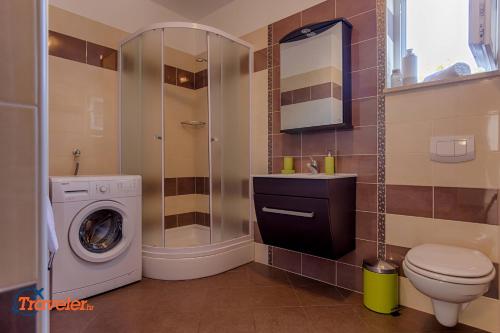 a bathroom with a washing machine and a washer at Luxury and modern villa with pool near beach by Traveler tourist agency Krk - ID 2138 in Vrh