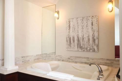 a bathroom with a bath tub with a sink at Quality Inn & Suites Downtown in Charlottetown
