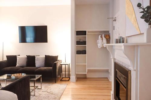 a living room with a couch and a fireplace at Quality Inn & Suites Downtown in Charlottetown