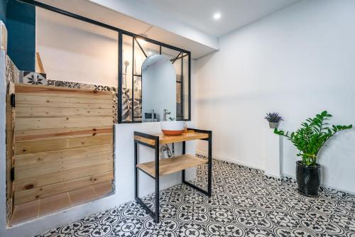 a room with a wooden door and a table at HoLo Fairy House Saigon - Serviced Homestay in Ho Chi Minh City