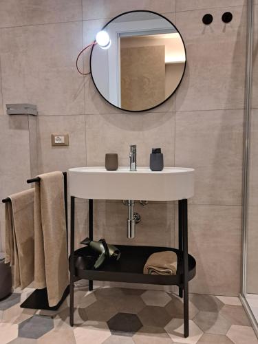 a bathroom with a sink and a mirror at Casa moderna nel centro di Imola in Imola
