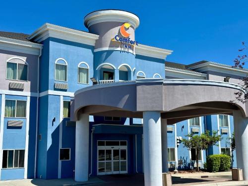a blue building with a bird on the top of it at Comfort Inn Ogden near Event Center in Ogden