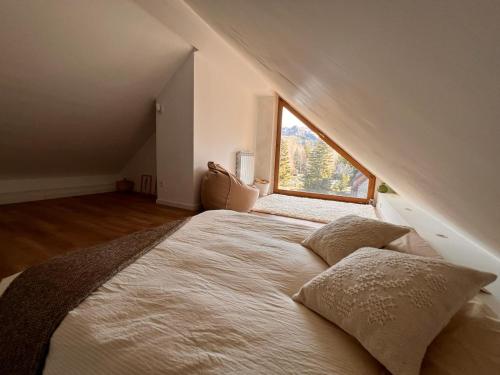 a bedroom with a large bed with a window at Piz Gloria 3 in Formigal