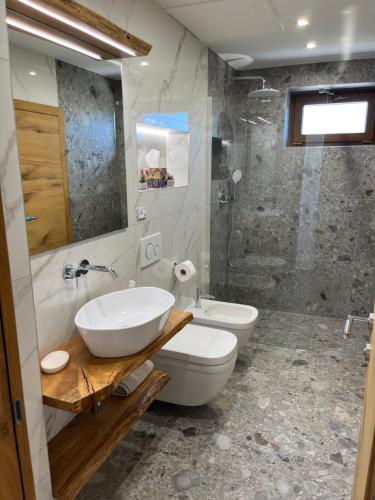 a bathroom with a sink and a toilet and a shower at Apartma Rozi Deluxe in Koper
