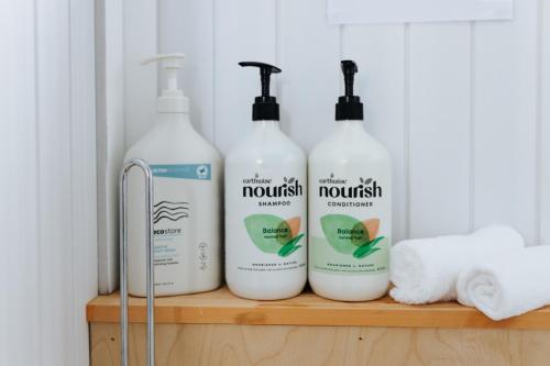 a group of four bottles of laundry detergent on a shelf at Sweet Hart 1 by Tiny Away in Tamahere