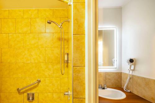 a bathroom with a shower and a sink at Clarion Pointe La Malbaie in La Malbaie