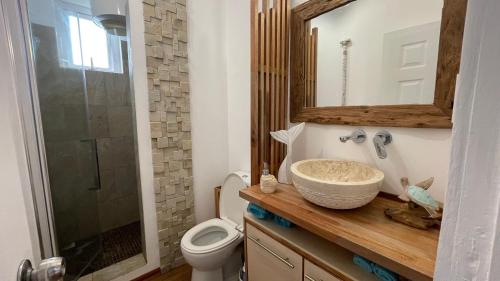 a bathroom with a sink and a toilet and a shower at Lovely beach front house 3 bedrooms in Trou aux Biches Mauritius in Trou aux Biches