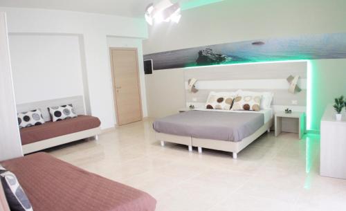 a bedroom with a bed and a couch at A'MANTIA HOTEL in Amantea