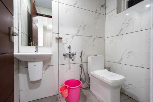 a bathroom with a white toilet and a sink at GRACE REGENCY in Ernakulam