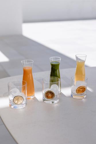 a group of four glass vases sitting on a table at THE FLAG HOTEL Marbella, Estepona Adult Recommended in Estepona