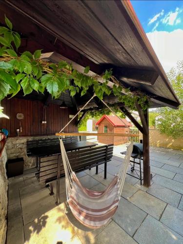a couple of hammocks sitting on a patio with a piano at Apartmán D+D in Zázrivá