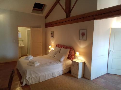 a bedroom with a white bed and two lamps at Occ34 - Capestang - Manoir in Capestang