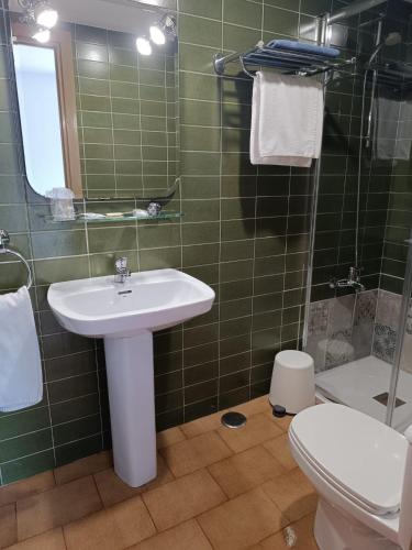 a bathroom with a sink and a toilet and a shower at Hotel Santa María in Palos de la Frontera