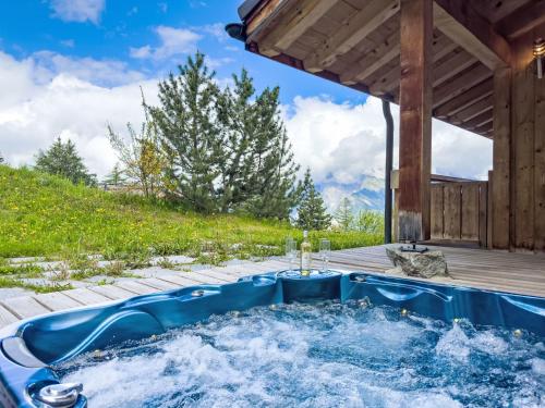 a hot tub in the backyard of a house at Chalet Gingembre 12 by Interhome in Nendaz