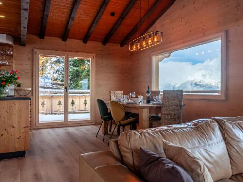 a living room with a couch and a table at Chalet Le Loup- le Renard et la Belette by Interhome in Nendaz