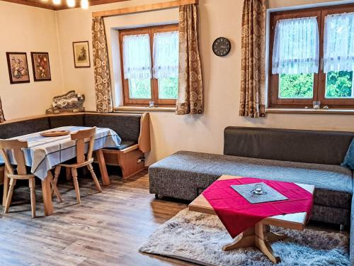 a living room with a table and a couch at Apartment Nicole by Interhome in Maishofen