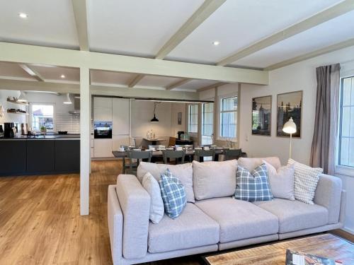 a living room with a couch and a kitchen at Holiday Home Melvill by Interhome in Dittishausen