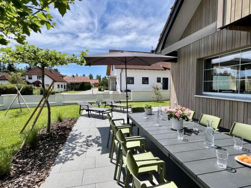 a patio with a table and chairs and an umbrella at Holiday Home Melvill by Interhome in Dittishausen