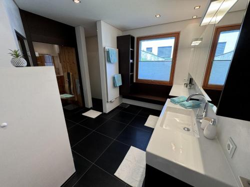 a bathroom with two sinks and a large window at Holiday Home Villa Renate by Interhome in Landeck