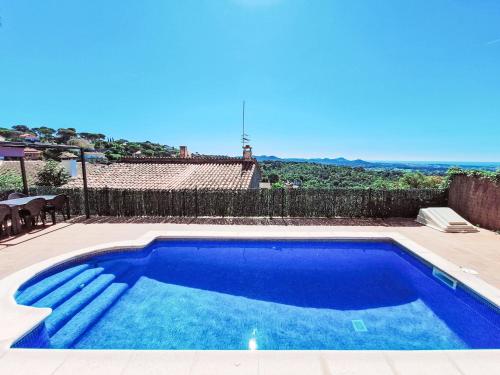 a large blue swimming pool in a yard at Holiday Home Panoramic by Interhome in Tordera