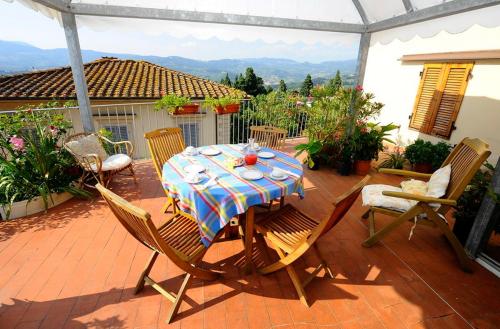 a table and chairs on a patio with a view at Albergo Villa Sorriso in Fiesole