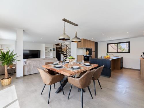 a dining room and living room with a table and chairs at Holiday Home Denneweiller by Interhome in Denneville