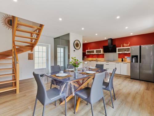 a kitchen and dining room with a table and chairs at Holiday Home La Bergerie by Interhome in Créances