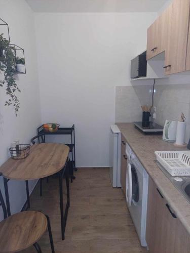 a kitchen with a table and a sink and a counter top at Apartament Centrum przy Placu Zwycięstwa in Gryfice