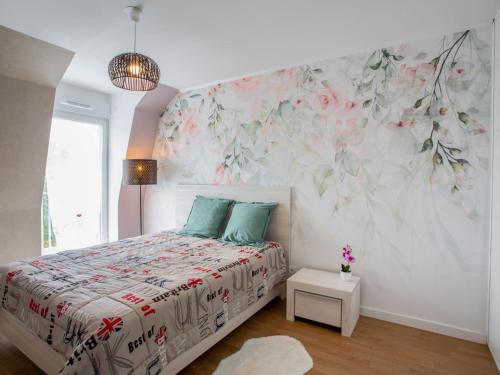- une chambre avec un lit orné d'un mur fleuri dans l'établissement Apartment Côté Port by Interhome, à Pornic